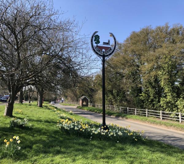 Village sign bus shelter and railings